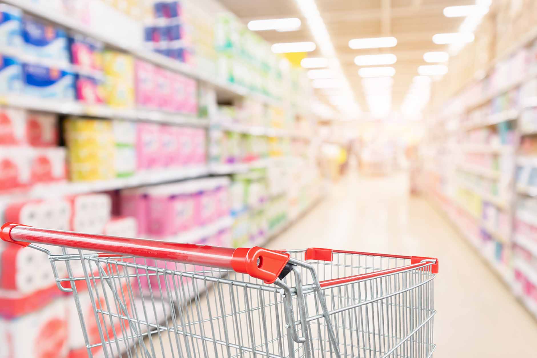 Empty,Shopping,Cart,With,Abstract,Blur,Supermarket,Discount,Store,Aisle